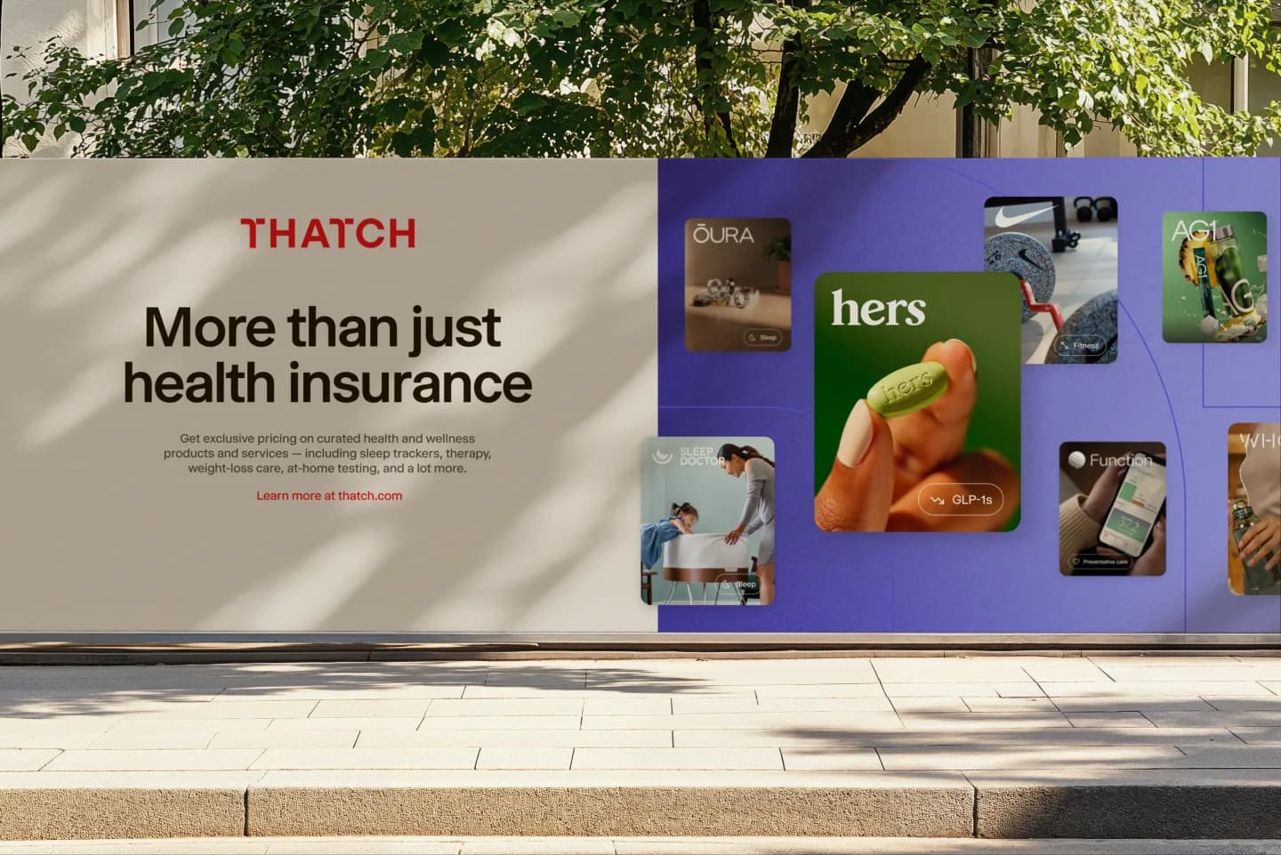 A street-level billboard reading "More than just health insurance" beside marketplace cards on an indigo panel