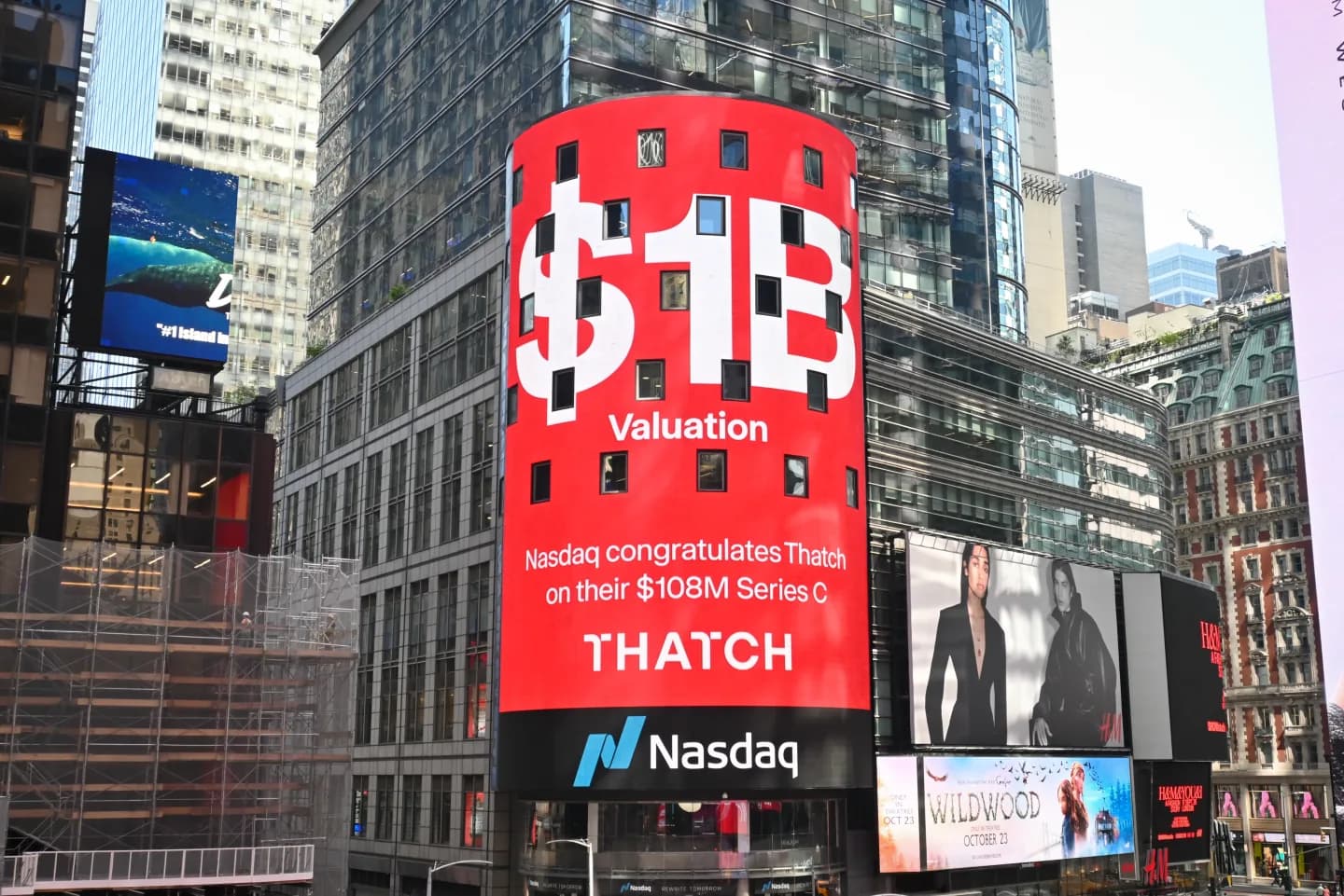 The Nasdaq tower in Times Square in Thatch red, reading "$1B Valuation" above "Nasdaq congratulates Thatch on their $108M Series C"